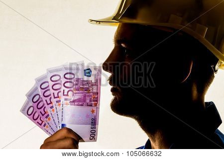 a worker in a business enterprise (craftsmen) with money bills in his hand