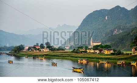 Calm river with boats in the National Park of Phong Nha Ke Bang, Vietnam