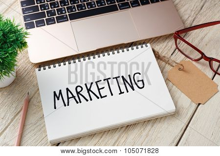 Marketing Concept With Laptop On Wood Desk