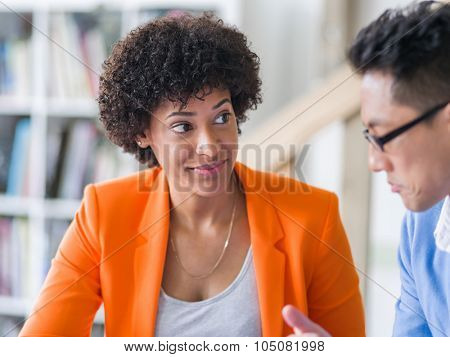 Two desingers working on a project together in office