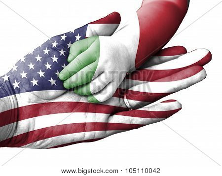 Adult Man Holding A Baby Hand With United States And Italy Flags Overlaid. Isolated On White
