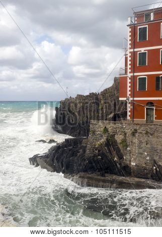 Riomaggiorre Cinque Terre old building raging stormy sea against cliffs
