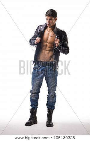 Handsome young man wearing leather jacket on naked torso, isolated over white