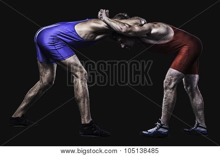 Two wrestlers holding each other in stand isolated