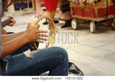 A Man Is Playing Tambourine At The Park
