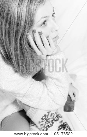 Beautiful blond young woman in knitted sweater