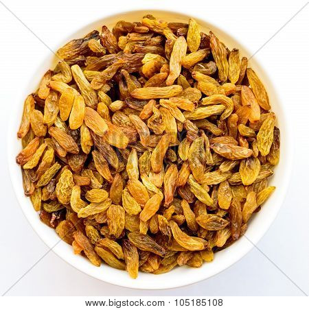 Fine golden variety raisins kept in a bowl on a white background