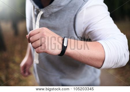 Closeup Of Fitness Bracelet During Park Jog