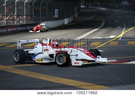 KUALA LUMPUR, MALAYSIA - AUGUST 09, 2015: Single seater racing cars race in the city street circuit in the Formula Masters China Series Race at the 2015 Kuala Lumpur City Grand Prix.