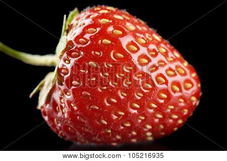 Macro View Of Whole Strawberry Isolated On Black