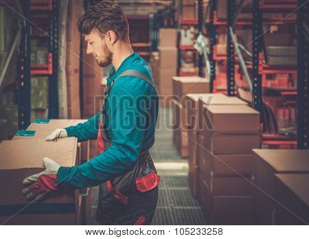 Porter carrying boxes in a warehouse 