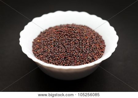 Organic brown mustard in white bowl.