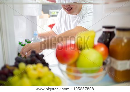 Taking cold bear from fridge