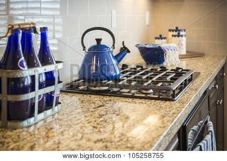 Beautiful Marble Kitchen Counter and Stove With Cobalt Blue Decor.
