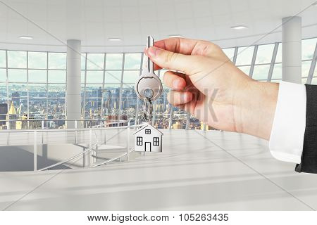Hand With Key From A New Office
