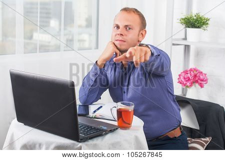 Businessman ssitting on the table and points, gives order