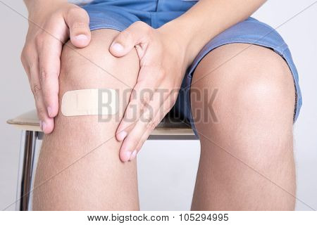 Close Up Of Male Knee With Adhesive Plaster