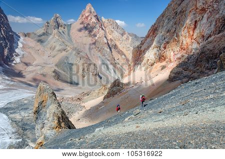 Two men climbing on the top.