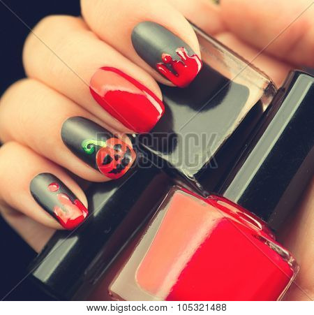 Halloween Nail art design. Nail Polish. Beauty hands. Trendy Stylish Colorful Nails and Nailpolish. Black matte nailpolish with blood drips and pumpkin