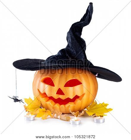 Halloween pumpkin head jack lantern with burning candles isolated on white background. Halloween holidays art design, celebration. Carved Halloween Pumpkin in witch hat with a spider