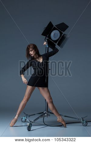The Beautiful Ballerina Posing On Dack Blue Background