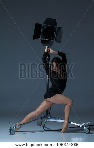 The Beautiful Ballerina Posing On Dack Blue Background