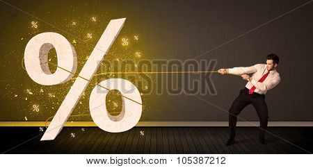 Business man pulling rope with big procent symbol sign concept on background