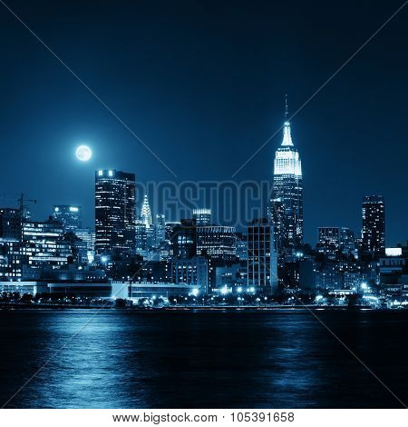 Moon rise over midtown Manhattan with city skyline at night
