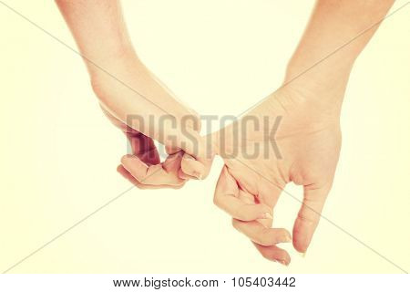Woman's and man's hands together.