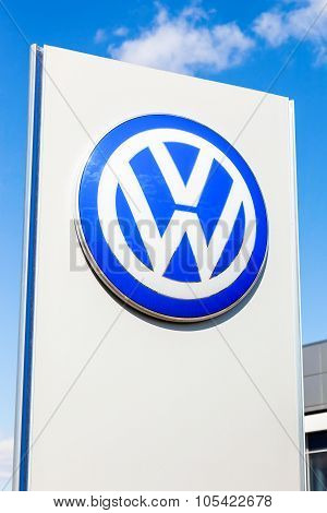 Official Dealership Sign Of Volkswagen Against Blue Sky