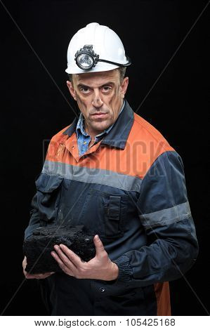 coalminer holds out a large chunk of energy rich coal