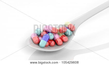 Colorful caplets inside a spoon, isolated on white background.
