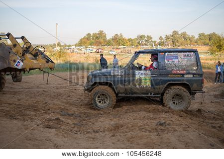 RUSSIA, PUSHKINO -?? 20 SEP, 2014: Bulldozer is pulling off-road vehicle at Rainforest Challenge Russia Autumn 2014 PRO-X.