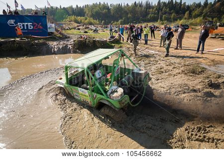 RUSSIA, PUSHKINO -?? 20 SEP, 2014: Off-road vehicle is driving in water obstacle during Rainforest Challenge Russia Autumn 2014 PRO-X at sunny day.