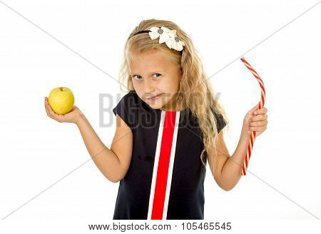 Little Pretty Female Child Choosing Dessert Holding Unhealthy But Tasty Red Candy Licorice And Apple