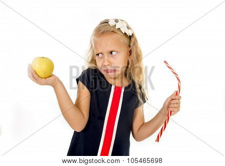 Little Pretty Female Child Choosing Dessert Holding Unhealthy But Tasty Red Candy Licorice And Apple