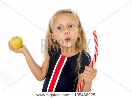 Little Pretty Female Child Choosing Dessert Holding Unhealthy But Tasty Red Candy Licorice And Apple