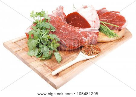 uncooked meat : raw fresh beef pork rib and fillet ready to cooking with garlic and green stuff over wood isolated on white background