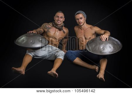 Male Drummers Drumming on Steel Drums in Studio