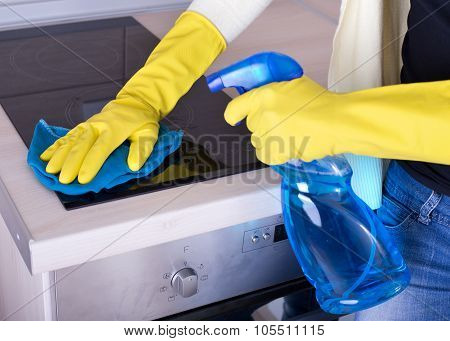 Woman Cleaning Cooker