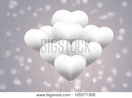 White balloons as love symbol on blurred background.