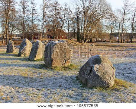 The Big Stones Standing In The Snow Field In Winter