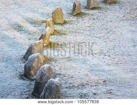 The Big Stones Standing In The Snow Field In Winter