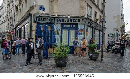 People gather on a street corner in Marais