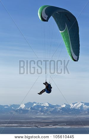 Paraglider Flying On Background Of Mountain And Sea
