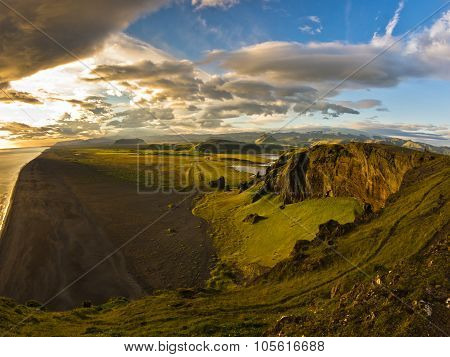 Sunset on a black beach, a view from Dyrholaey rock, Iceland