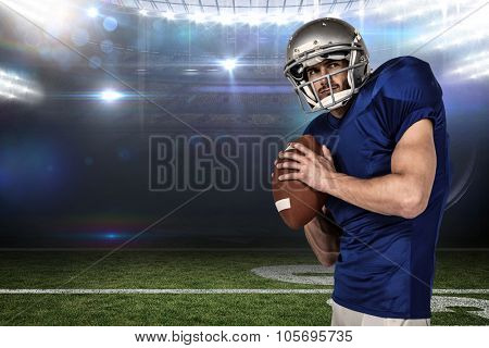 Sports manto throwing the ball against american football arena
