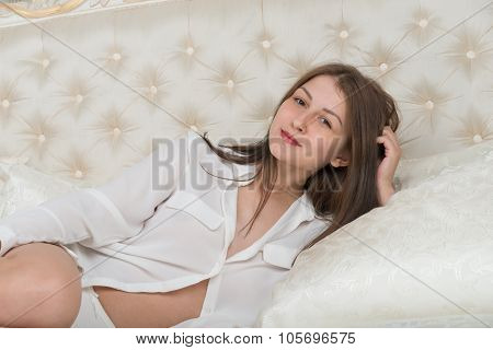 Portrait Of A Cute Girl On The Bed