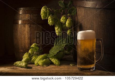 Still Life with a keg of beer and draft beer by the glass.