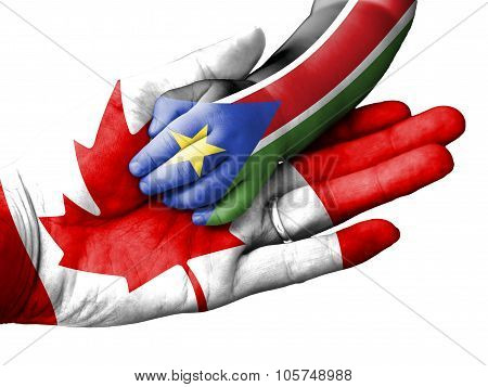 Adult Man Holding A Baby Hand With Canada And South Sudan Flags Overlaid. Isolated On White